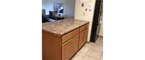 Kitchen island and black fridge