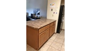 Kitchen island and black fridge