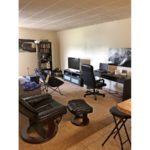 Living room with seating, bookshelf, desk, TV/TV stand