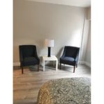 Living area with armchairs and accent table with lamp