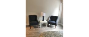 Living area with armchairs and accent table with lamp