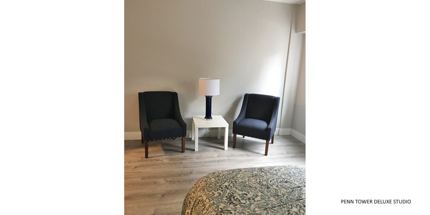 Living area with armchairs and accent table with lamp