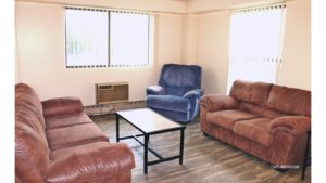 Living Room with couches, recliners, accent tables, and wood-style flooring