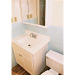 Bathroom with vanity, toilet, and medicine cabinet