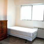 Bedroom with twin bed, and chest of drawers