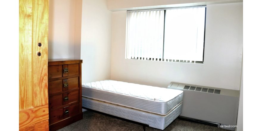 Bedroom with twin bed, and chest of drawers