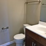 Bathroom with mirror, vanity and toilet.