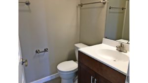 Bathroom with mirror, vanity and toilet.