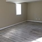 Unfurnished bedroom with gray wood-style flooring.