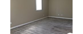 Unfurnished bedroom with gray wood-style flooring.