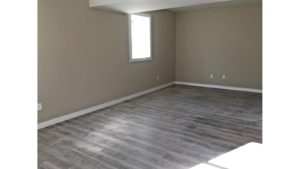 Unfurnished bedroom with gray wood-style flooring.