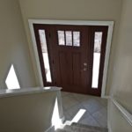 Split entry with wood door and carpets stairs