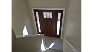 Split entry with wood door and carpets stairs