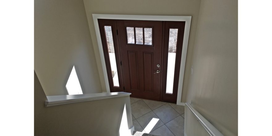 Split entry with wood door and carpets stairs