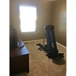 Carpeted bedroom with window, tv, tv stand exercise equipment