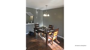 Dining room with wood-style flooring, table and chairs, and chandelier