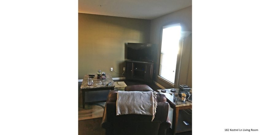 Living room with tv, tv stand, accent rug, wood-style flooring, chairs and accent tables