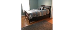 Bedroom with full bed and throw rug