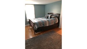 Bedroom with full bed and throw rug