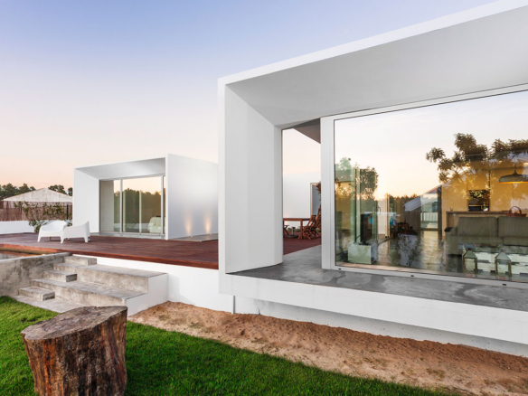 a house with a large glass window on the side of it