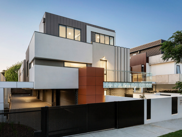 a modern house with a black fence in front of it