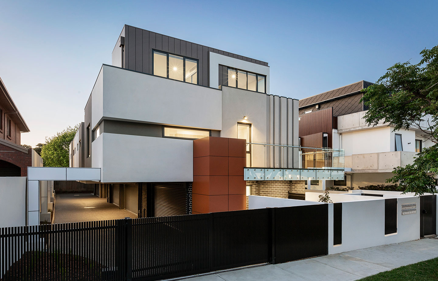 a modern house with a black fence in front of it