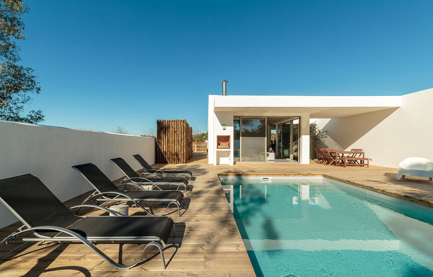 a swimming pool with lounge chairs around it