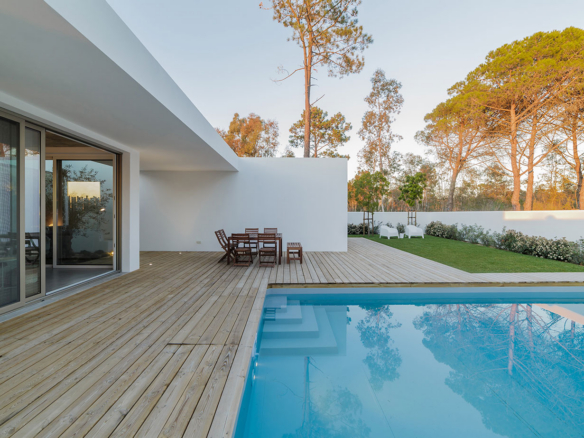 a swimming pool with a wooden deck next to it