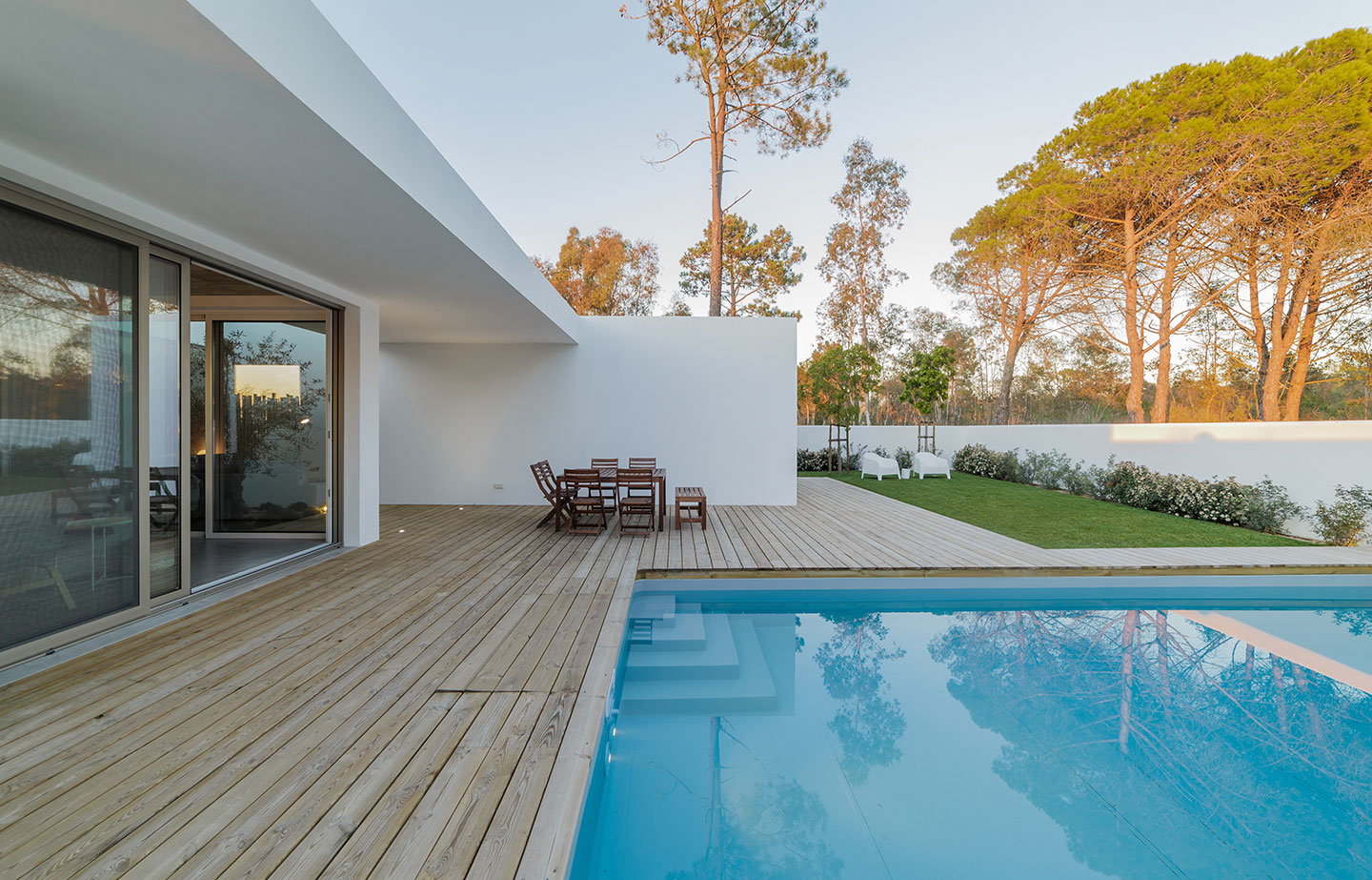 a swimming pool with a wooden deck next to it