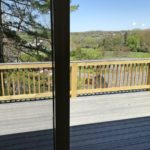 Screen door onto wooden back deck