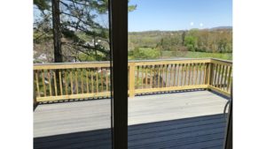 Screen door onto wooden back deck