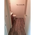 Bathroom with shower/tub combo, toilet, vanity and closet.