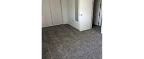 Unfurnished bedroom with gray carpet.