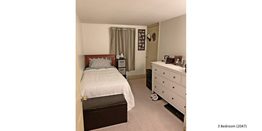 Bedroom with twin bed, dresser, window and storage ottoman