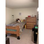 Bedroom with twin bed, dresser, and bookshelf