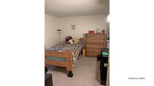 Bedroom with twin bed, dresser, and bookshelf