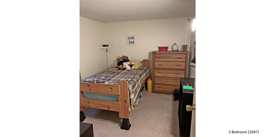 Bedroom with twin bed, dresser, and bookshelf