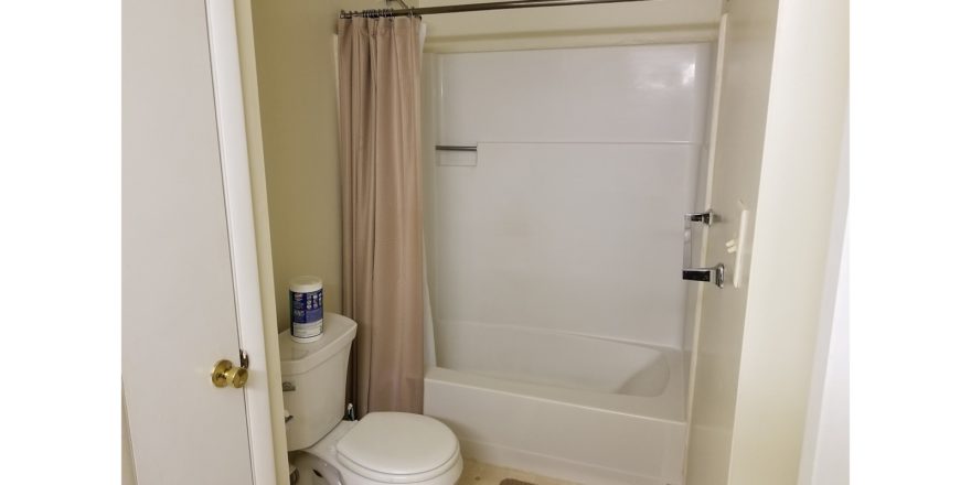 Bathroom with toilet and tub/shower combo