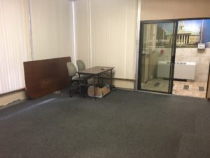 Carpeted office space with tables and chairs