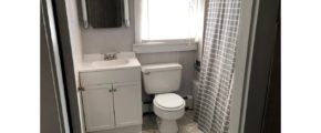 Bathroom with toilet, tub/shower combo with curtain, vanity, and medicine cabinet with a mirror