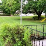 Large yard with bench, tire swing, and small play fort