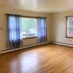 Unfurnished living room with hardwood floor and large picture window