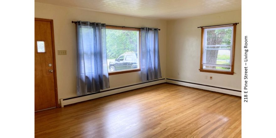 Unfurnished living room with hardwood floor and large picture window