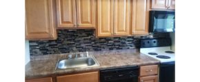 Kitchen with wood-tone cabinets and backsplash