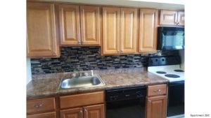 Kitchen with wood-tone cabinets and backsplash