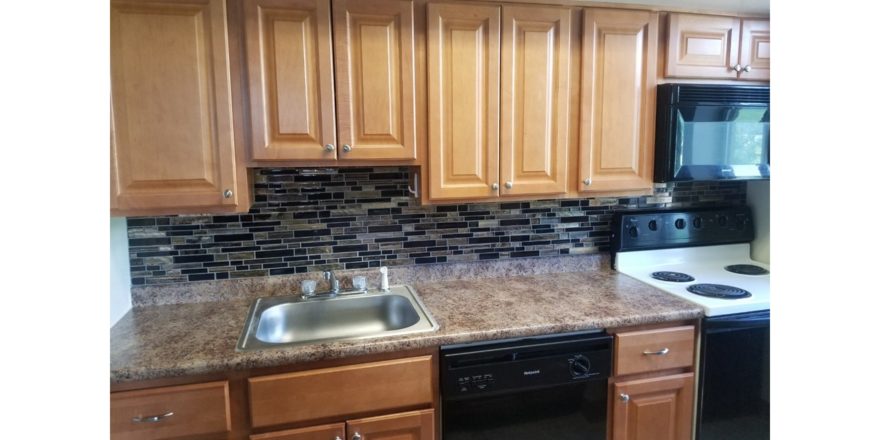 Kitchen with wood-tone cabinets and backsplash
