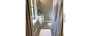 Bathroom with tub/shower combo with curtain, toilet, and vanity, and medicine cabinet with mirror