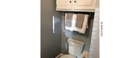 Bathroom with toilet and cabinet above the toilet