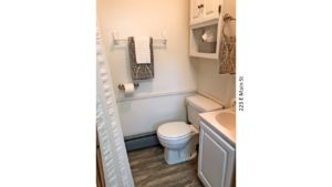 Bathroom with vanity, toilet, and medicine cabinet above the toilet