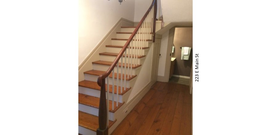 Entry hallway with wooden floors and stairs